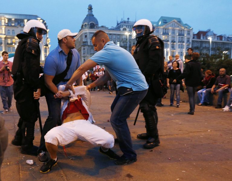   Plainclothed police detain a Polish fan during the Euro 2012 soccer championship group a match between Poland and Russia in downtown Warsaw, Poland , Tuesday, June 12, 2012. (AP Photo/Czarek Sokolowski)  