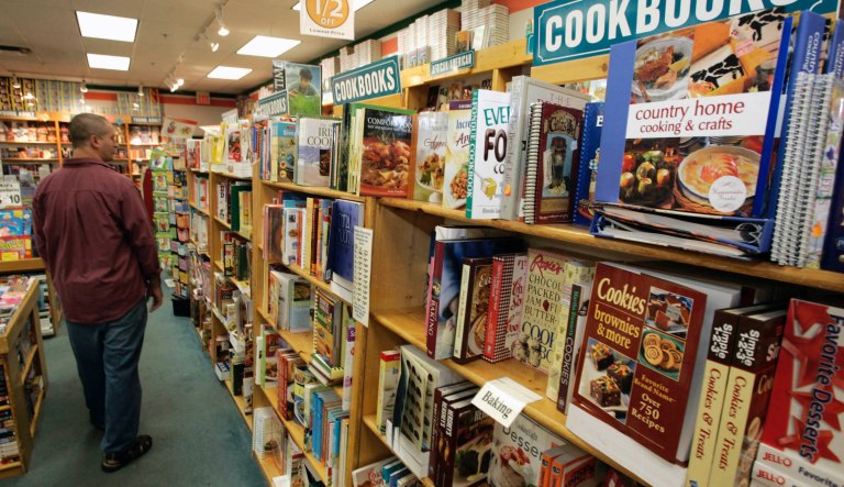 A man walks down the aisle past the cookbooks at a bookstore at the outlet mall in Grove City, Pa. Friday, Sept. 5, 2008.