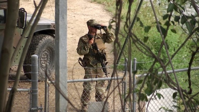 FILE - In this April 10, 2018, file frame from video, a National Guard troop watches over Rio Grande River on the border in Roma, Texas. The deployment of National Guard members to the U.S.-Mexico border at President Donald Trump's request was underway with a gradual ramp-up of troops under orders to help curb illegal immigration.