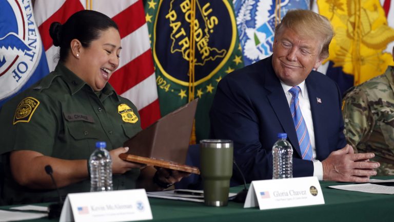 President Donald Trump receives a gift from Gloria Chavez with U.S. Customs and Border Protection at a roundtable on immigration and border security at the U.S. Border Patrol Calexico Station in Calexico, Calif., Friday April 5, 2019. Trump headed to the border with Mexico to make a renewed push for border security as a central campaign issue for his 2020 re-election.