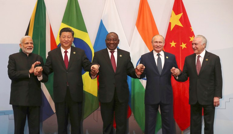 Members of the major emerging national economies group BRICS, with from left, Indian Prime Minister Narendra Modi, China's President Xi Jinping, South African President Cyril Ramaphosa, Russia's President Vladimir Putin, and Brazil's President Michel Temer, as they pose together for a group photo at the BRICS summit in Johannesburg, South Africa, Thursday, July 26, 2018.