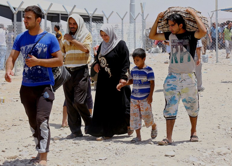Refugees fleeing from Mosul head to the self-ruled northern Kurdish region in Irbil, Iraq, 350 kilometers (217 miles) north of Baghdad, Tuesday, June 10, 2014. Islamic militants overran parts of Iraq's second-largest city of Mosul on Tuesday, driving security forces from their posts and seizing the provincial government headquarters, security bases and other key buildings. Prime Minister Nouri al-Maliki pressed parliament to declare a state of emergency.  (AP Photo)