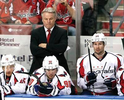 Washington Capitals head coach Dale Hunter, rear, looks on during the first period of an NHL hockey game against the Florida Panthers, Monday, Dec. 5, 2011, in Sunrise, Fla. The Panthers defeated the Capitals 5-4.(AP Photo/Wilfredo Lee)