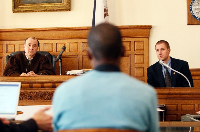 Judge Paul Miller, left, and UI Police Detective Brian Meyer, right, listen as Leon Spies (not pictured), lawyer for Cedric Everson speaks during Everson's trial for for second-degree sexual abuse. (AP Photo)Â 