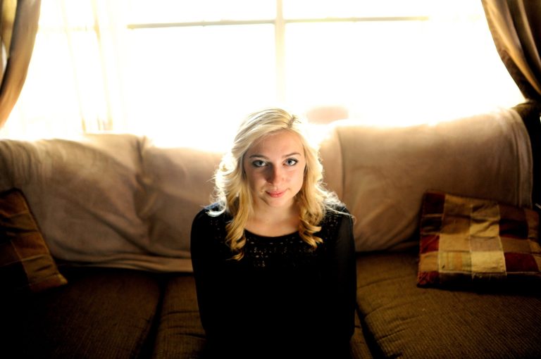 Sarah Ball, a victim of cyber bullying during her high school years, sits for a portrait at her home on Wednesday, Oct. 23, 2013, in Spring Hill, Fla. Ball, now a student at a nearby community college, maintains a Facebook site called 