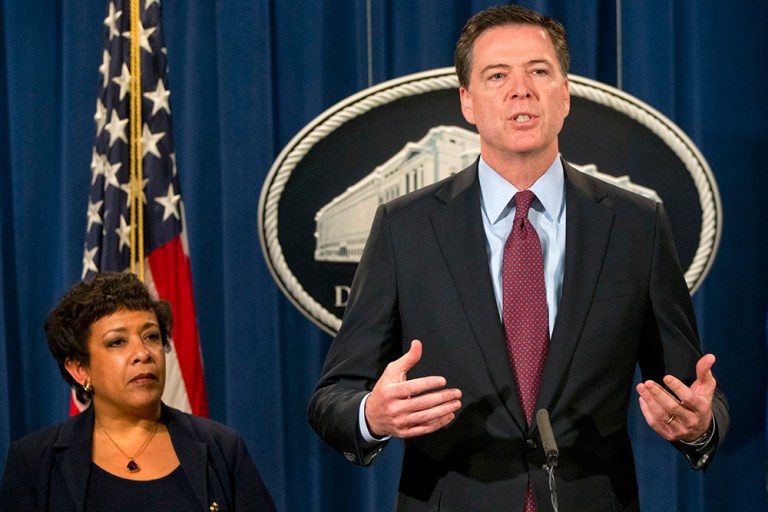 Attorney General Loretta Lynch listens at left as FBI Director James Comey speaks during a news conference at the Justice Department in Washington, Thursday, March 24, 2016. (AP Photo/Jacquelyn Martin)