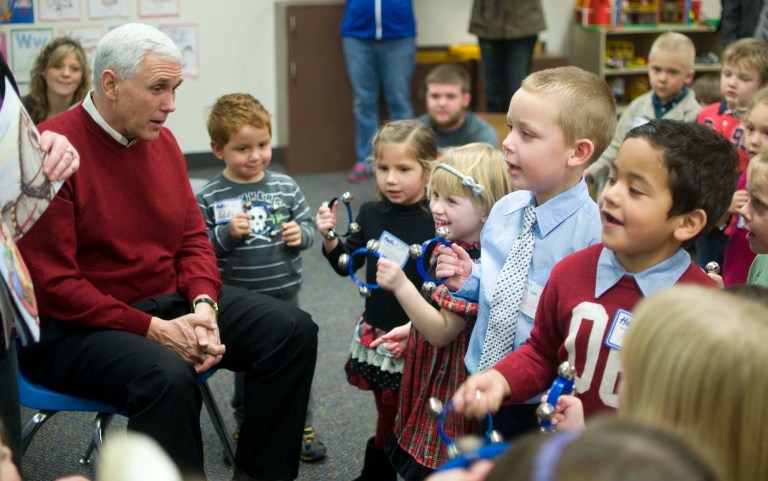Indiana Gov. Mike Pence sings Jingle Bells with preschool students Friday, Dec. 20, 2013, at Jay County High School in Portland, Ind. (AP Photo/The Commercial Review, Ray Cooney) THE STAR PRESS OUT