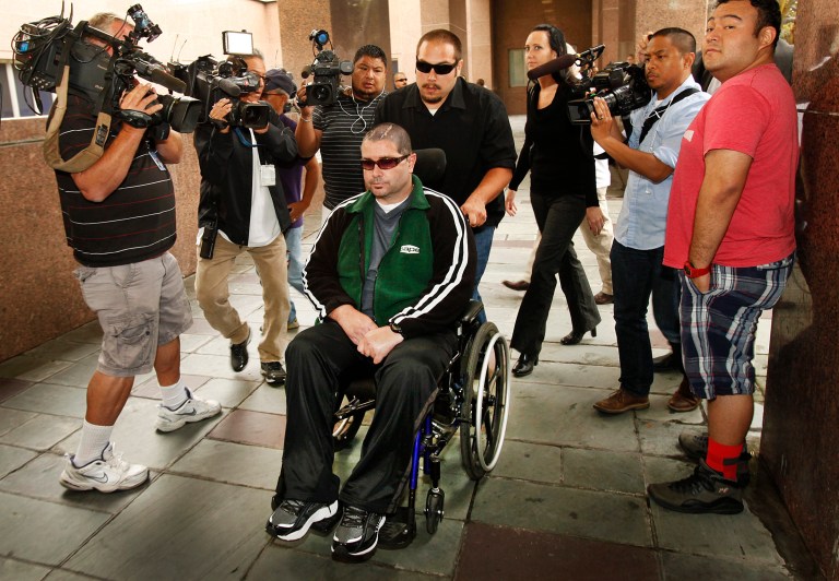 A wheelchair bound Bryan Stow, assisted by a caregiver, is surrounded by family and media as he is led into the Los Angeles County Superior Courthouse in downtown Los Angeles, Wednesday, June 25, 2014, as the trial goes into the last day before closing arguments for the trial of Stow's lawsuit against former Dodgers owner Frank McCourt and three team entities he created. The suit filed on behalf of the San Francisco Giants fan alleges the franchise was negligent for not having enough security to prevent an Opening Day 2011 attack by Dodger fans that left him with permanent brain damage. (AP Photo/Los Angeles Times, Al Seib) MANDATORY CREDIT