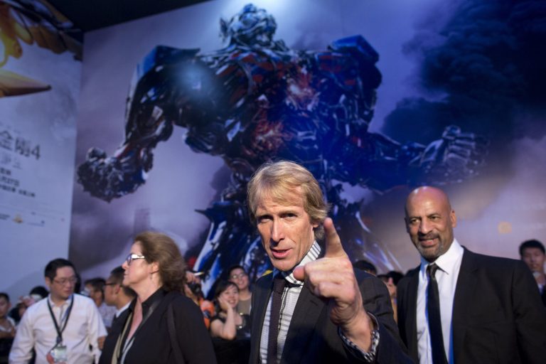 FILE - In this June 23, 2014 file photo, director Michael Bay, center, gestures to fans as he attends the premiere of movie 