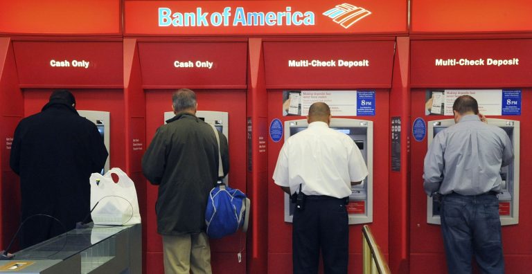 FILE - In this file photo taken Oct. 16, 2009, customers use ATM machines at a Bank of America branch office in Boston. The FDIC reported that the U.S. banking industry earned $37.2 billion in the first quarter of 2014, down from $40.3 billion in the same period in 2013. (AP Photo/Lisa Poole, File)