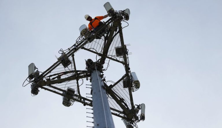 Workers on a telephone pole.