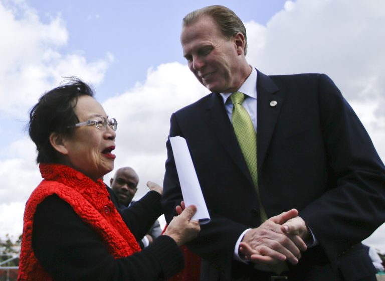 San Diego mayoral candidate Kevin Faulconer engages in conversation with supporter Lilly Cheng during a campaign event, in San Diego. Faulconer easily topped a field of 11 candidates in a first round of voting by dominating in wealthier neighborhoods north of the freeway. (AP Photo/Lenny Ignelzi)