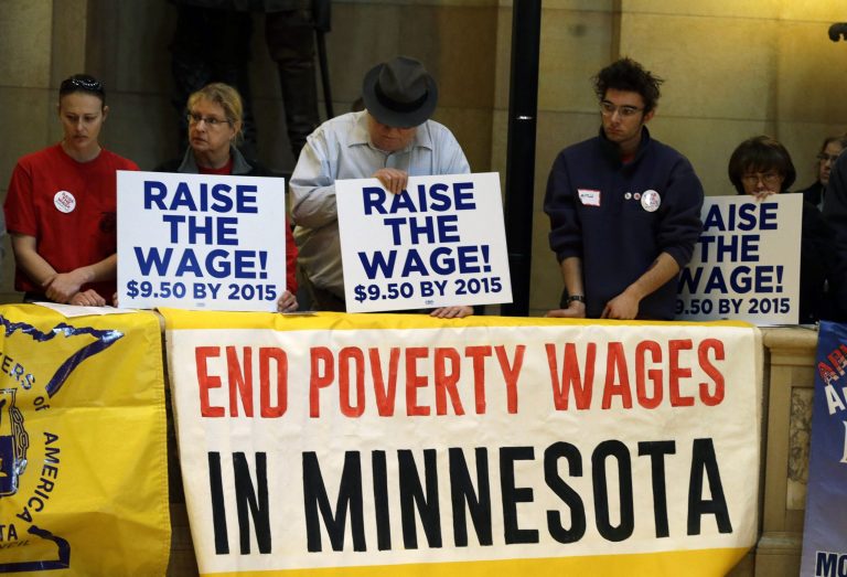 Demonstrators rally at the state Capitol, calling for lawmakers to raise the minimum wage before the 2014 Minnesota Legislature convened Feb. 25 in St. Paul, Minn. (AP Photo/Jim Mone)