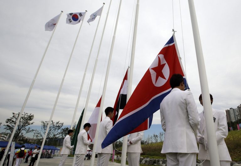 A North Korean flag, right, is prepared for a welcoming ceremony at the Flag Plaza of the Athlete's Village for the 2014 Incheon Asian Games in Incheon, west of Seoul, South Korea, Thursday, Sept. 18, 2014. The games will be held in the South Korea's west city from Sept. 19 to Oct. 4. (AP Photo/Lee Jin-man)