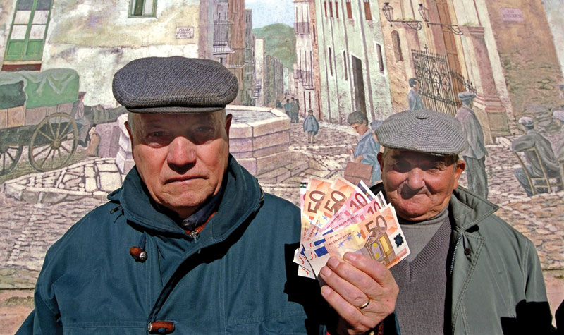 Italians hold their first euros when the currency began circulating in 2002.