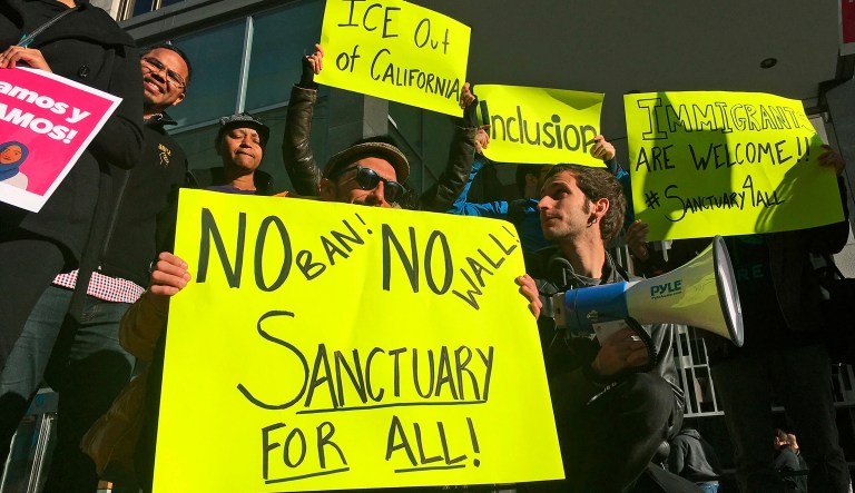 FILE - In this April 14, 2017, file photo, protesters rally outside a courthouse in San Francisco. U.S. Judge William Orrick struck down an immigration law Friday, Oct. 5, 2018, that the Trump administration has used to go after cities and states that limit cooperation with immigration officials.