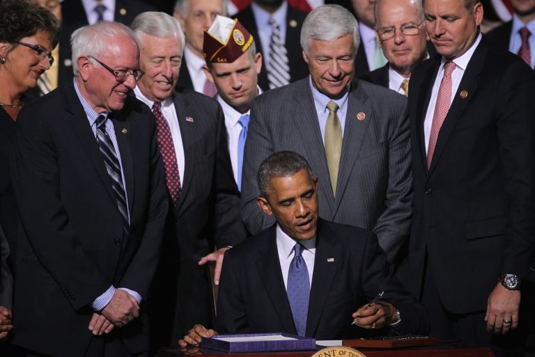 FORT BELVOIR, VA - AUGUST 07: Flanked by members of Congress, President Obama signs the Veterans Choice Act of 2014 into law. (Getty images)