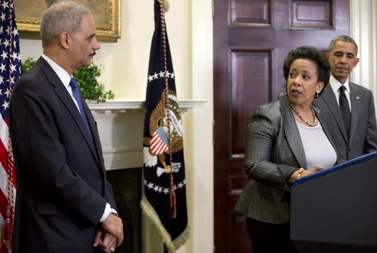 In this Nov. 8, 2014, file photo, attorney Loretta Lynch, center, looks to Attorney General Eric Holder as with President Barack Obama at right, in the Roosevelt Room of the White House in Washington where the president announced that he will nominate Lynch to replace Holder as Attorney General. A Donald Trump administration could radically reshape the Justice Department, particularly civil rights efforts that became one of its most pressing and high-profile priorities over the past eight years. During that time it's been guided by the country's first two black attorneys general, both appointed by the first black president.(AP Photo/Carolyn Kaster, File)