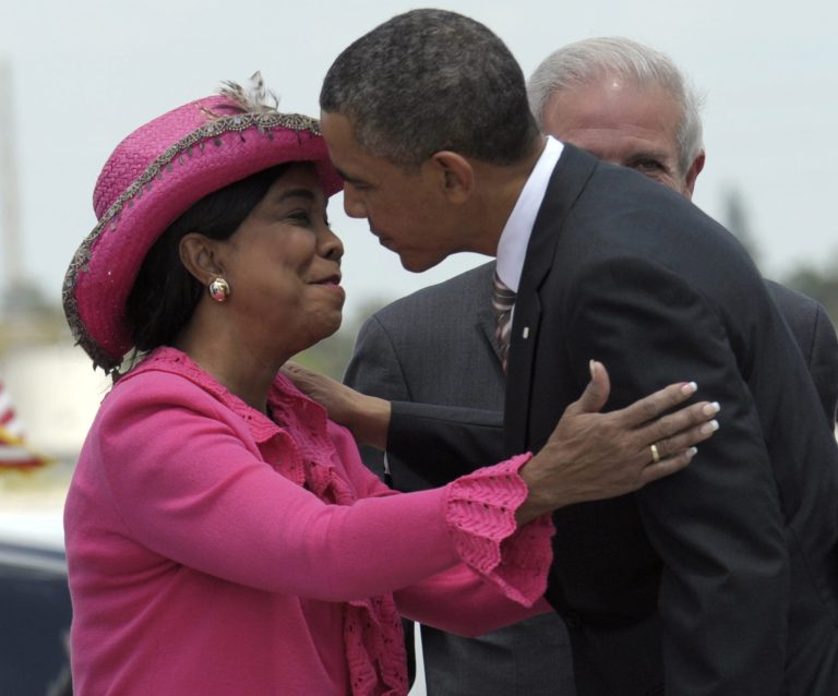 President Barack Obama is greeted by Rep. Frederica Wilson, D-Fla., after walking down the steps of Air Force One at Miami International Airport in Miami, Friday, March 29, 2013. (AP Photo/Susan Walsh)
