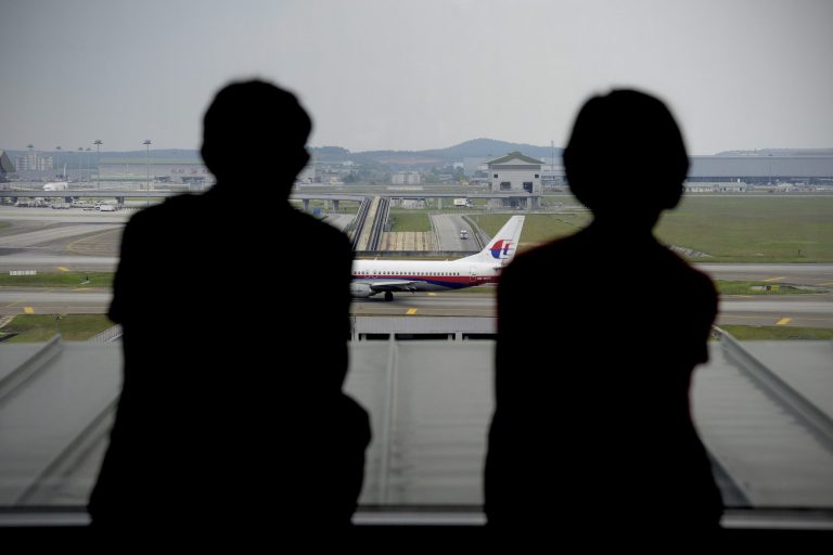 FILE - In this April 10, 2014 file photo, a couple are silhouetted as they watch a Malaysia Airlines plane on the tarmac from the viewing gallery at Kuala Lumpur International Airport in Sepang, Malaysia. Malaysia Airlines said its net loss expanded 59 percent in the first quarter, hit by loss of revenue from China after the disappearance of Flight 370 two months ago. The flag carrier said Thursday, May 15, 2014, its net loss surged to 443.4 million ringgit ($137.8 million), up from 278.8 million ringgit in the January-to-March period last year. Revenue however, still rose 1.7 percent to 3.6 billion ringgit ($1.1 billion).  (AP Photo/Joshua Paul, File)