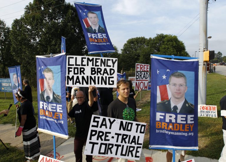 Supporters of Army Pfc. Bradley Manning hold up banners and signs as they protest outside of the gates at Fort Meade, Md., Wednesday, Aug. 21.  (AP/Jose Luis Magana)