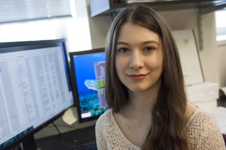 This handout photo taken Tuesday, Feb. 25, 2014, provided by The Rockefeller University, shows Elana Simon, 18, of New York, pictured in a laboratory at The Rockefeller University in New York. The teen survivor of a rare liver cancer spearheaded a study, published Thursday in the journal Science, that led a team of researchers to find a gene flaw involved with the disease. (AP Photo/Zach Veilleux, The Rockefeller University)