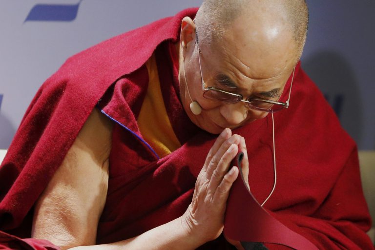 Tibetan spiritual leader the Dalai Lama acknowledges the audience before speaking at an event entitled: 