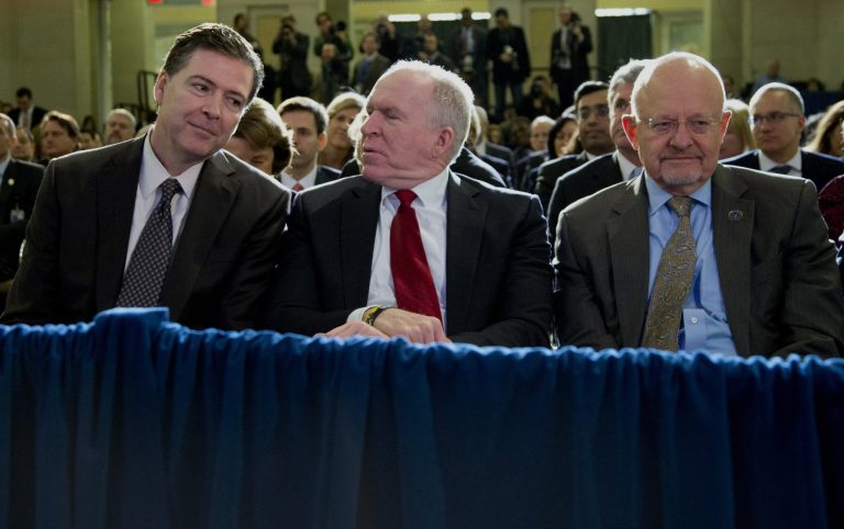 From left, FBI Director James Comey, CIA Director John Brennan, and Director of National Intelligence James Clapper sit together in the front row before President Barack Obama spoke about National Security Agency (NSA) surveillance, Friday, Jan. 17, 2014, at the Justice Department in Washington. The president called for ending the government's control of phone data from millions of Americans. (AP Photo/Carolyn Kaster)