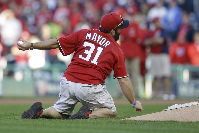 U.S. Army Sgt. 1st Class Brian Keaton, mimics a grenade toss for the ceremonial first pitch before Game 2 of baseball's NL Division Series between the Washington Nationals and the San Francisco Giants in Nationals Park, Saturday, Oct. 4, 2014, in Washington. (AP Photo/Patrick Semansky)