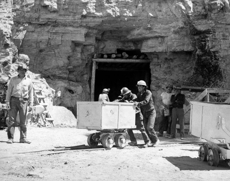 FILE - In this May 7, 1953, file photo, Navajo miners work at the Kerr McGee uranium mine at Cove, Ariz., on the Navajo reservation in Arizona. Kerr-McGee left abandoned uranium mine sites, including contaminated waste rock piles, in the Lukachukai mountains of Arizona and in the Ambrosia Lake area of New Mexico. The Lukachukai mountains are located immediately west of Cove, Ariz., and are a culturally significant part of the Navajo Nation. This site is among thousands that are part of the $5.15 billion settlement with Anadarko Petroleum Corp. with approximate amount of funding for cleanup efforts and details about the sites, in information provided by the Justice Department.  (AP Photo)