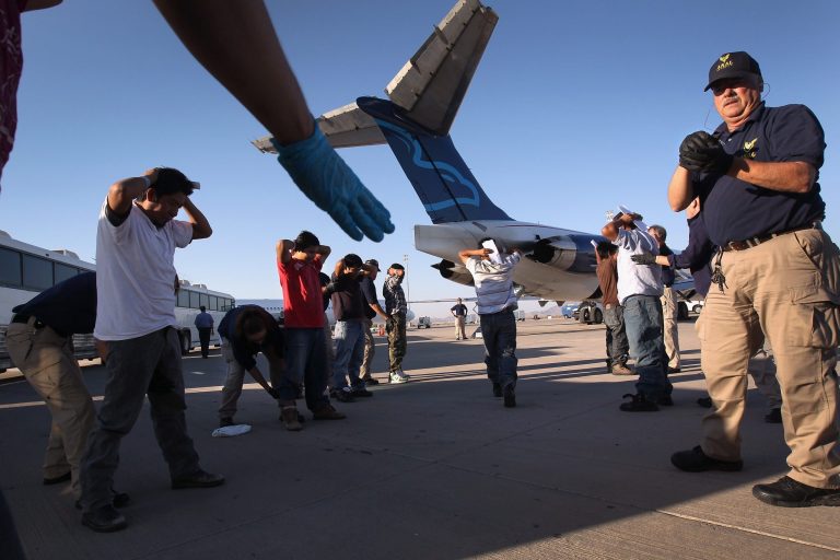 Undocumented Guatemalan immigrants are body searched before boarding a deportation flight to Guatemala City, Guatemala at Phoenix-Mesa Gateway Airport in Mesa, Arizona.  (Photo by John Moore/Getty Images)