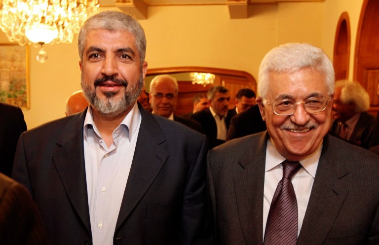 FILE - In this file photo provided on Nov. 24, 2011, by the office of Khaled Mashaal, Palestinian Hamas leader Khaled Mashaal, left, and Palestinian President Mahmoud Abbas are seen together during their meeting in Cairo, Egypt. A negotiator said Monday, May 26, 2014, that he expects a Palestinian unity government to be announced later this week in what would be a first significant step toward ending the crippling rift between Hamas and Fatah. (AP Photo/Office of Khaled Meshaal, File)