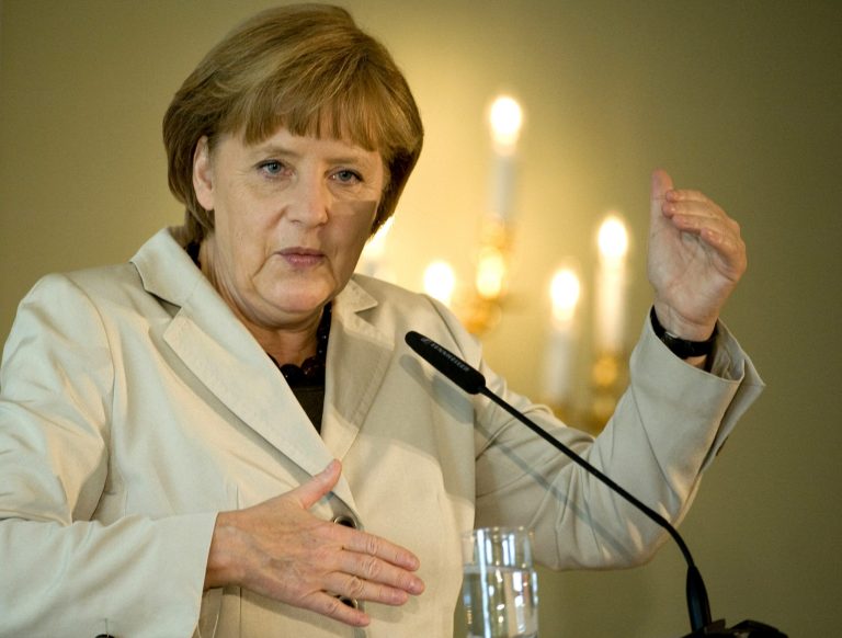   German Chancellor Angela Merkel gestures as she speaks at a conference of a group representing family-owned companies in Berlin, Friday, June 15, 2012. German Chancellor Angela Merkel has underlined her determination to reject pressure for quick solutions at the Group of 20 summit, saying Europe must tackle its problems 