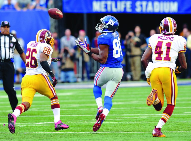 Bill Kostroun/AP
Victor Cruz got behind the Redskins' Josh Wilson and Madieu Williams for a 77-yard, game-winning touchdown Sunday for the Giants.