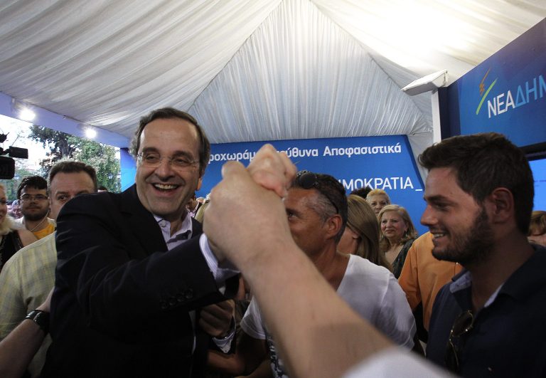   Greek conservative leader Antonis Samaras of New Democracy visits an elections kiosk in Syntagma square in central Athens, Monday, June 11, 2012. Greeks go to the polls again on Sunday, June 17. (AP Photo/Petros Karadjias)  