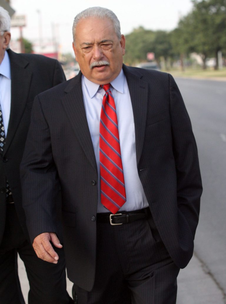 Former Hidalgo County Sheriff Lupe Trevino, left, walks to the federal courthouse in McAllen, Texas for his sentencing hearing on Thursday, July 17, 2014. Trevino was sentenced to five years in prison, months after he resigned and pleaded guilty to accepting illegal campaign contributions from a local drug trafficker. (AP Photo/The McAllen Monitor, Delcia Lopez)