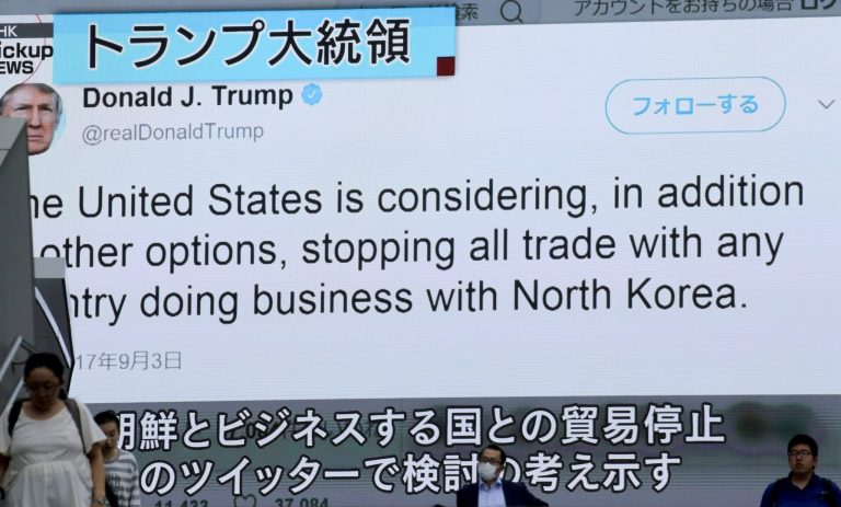 People walk by a TV news program showing Twitter of U.S. President Donald Trump while reporting North Korea's nuclear test, in Tokyo, Monday, Sept. 4, 2017. North Korea detonates its strongest ever nuclear test explosion and Trump takes to Twitter to criticize both North and South Korea, China and 