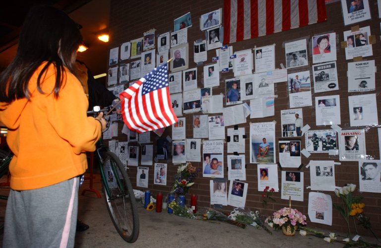 In this Sept. 15, 2001 photograph, a girl looks at posters of missing victims of the September 11 terrorist attacks on the World Trade Center in New York City.(AP Photo/Louis Lanzano)