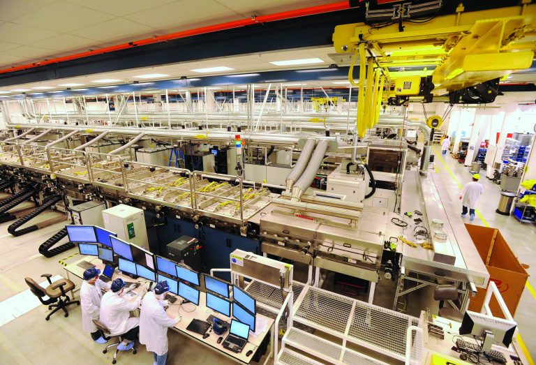FILE - In this Oct. 6, 2010 file photo, workers monitor a control bank at Solyndra's solar panel factory on in Fremont, Calif. Homeowners on the hunt for sparkling solar panels are lured by ads filled with images of pristine landscapes and bright sunshine, and words about the technology's benefits for the environment _ and the wallet. What customers may not know is that there's a dirtier side. While solar is a far less polluting energy source than coal, many panel makers are nevertheless grappling with a hazardous waste problem. Fueled partly by billions in government incentives, the industry is creating millions of solar panels each year and, in the process, millions of pounds of polluted sludge and contaminated water. (AP Photo/Noah Berger, File)