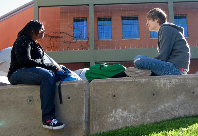 In this Feb. 21, 2011 photo, Konstynce McMarion, 18, left, and Jacob Amador, 17, talk on the Northwest Campus of Pima Community College in Tucson, Ariz. (AP File)
