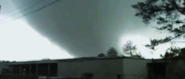 In this image made from video and released by WSB TV in Atlanta, a tornado moves through the town of Adairsville, Ga. on Wednesday, Jan 30, 2013. A fire chief says a storm that roared across northwest Georgia has left overturned vehicles on Interstate 75 northwest of Atlanta, and crews are responding to reports of people trapped in storm-damaged residential and commercial buildings. (AP Photo/WSB TV) MANDATORY CREDIT