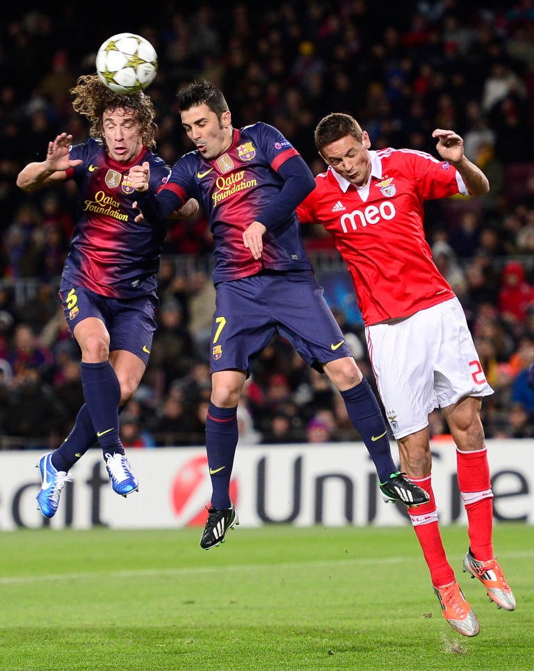   FC Barcelona's Carles Puyol, left, and David Villa, center, duel for the ball against Benfica's Nemanja Matic, from Serbia, during a group G Champions League soccer match at the Camp Nou stadium in Barcelona, Spain, Wednesday, Dec. 5, 2012. (AP Photo/Manu Fernandez)  
