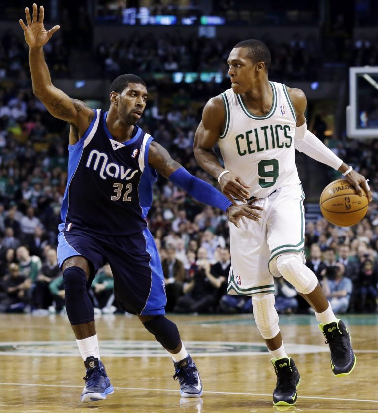   Boston Celtics guard Rajon Rondo (9) handles the ball against Dallas Mavericks shooting guard O.J. Mayo (32) during the second quarter of an NBA basketball game in Boston, Wednesday, Dec. 12, 2012. (AP Photo/Elise Amendola)  