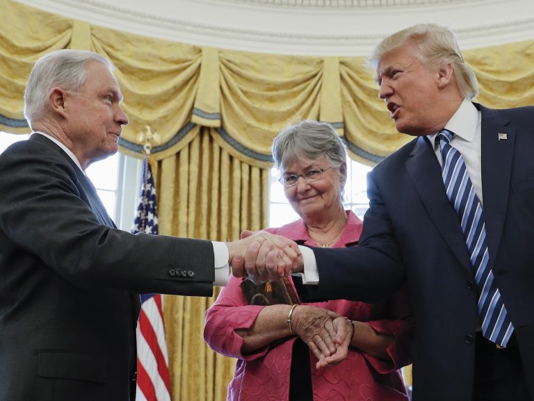 President Donald Trump shakes hands with Attorney General Jeff Sessions, accompanied by his wife Mary, after he was sworn-in by Vice President Mike Pence, Thursday, Feb. 9, 2017, in the Oval Office of the White House in Washington. (AP Photo/Pablo Martinez Monsivais)