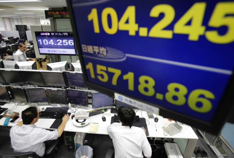 Money traders work under a screen indicating update of U.S. dollars against yen at a foreign exchange brokerage in Tokyo, Wednesday, Jan. 15, 2014. The euro was up 0.2 percent at $1.364 while the dollar rose 0.2 percent to 104.33 yen. (AP Photo/Shizuo Kambayashi)