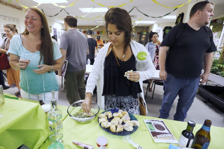 In this Thursday, July 10, 2014, photo, students taste a cannabis-infused dipping sauce prepared during a cooking class at the New England Grass Roots Institute in Quincy, Mass. The proliferation of marijuana edibles for medical and recreational use is giving rise to a cottage industry of foods, infused olive oils, cookbooks and classes as more states legalize marijuana use. (AP Photo/Michael Dwyer)