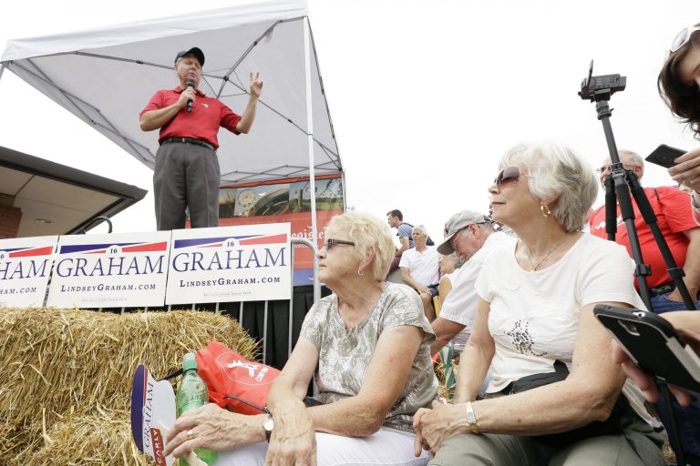 Fairgoers listen as Republican presidential candidate Sen. Lindsey Graham, R-S.C., speaks during a visit to the Iowa State Fair, Monday, Aug. 17, 2015, in Des Moines, Iowa. (AP Photo/Charlie Neibergall)