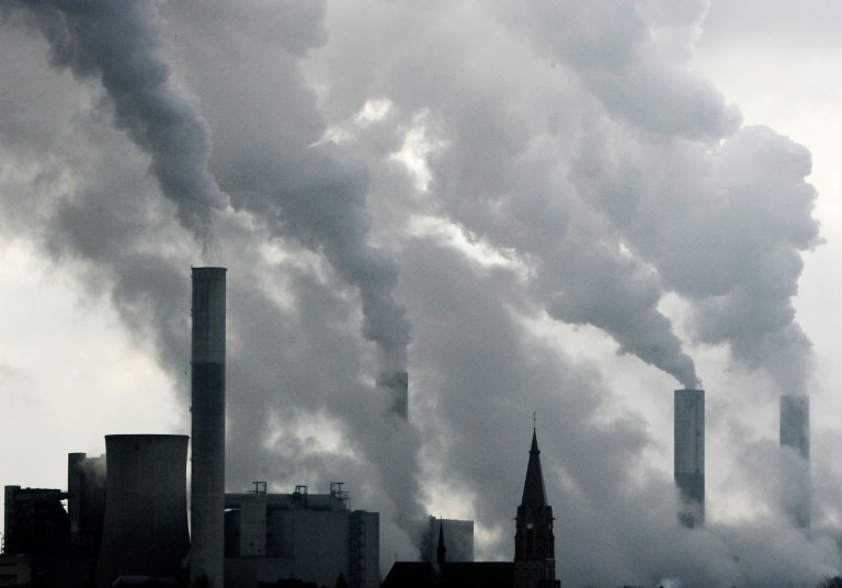 FILE - In this Feb. 25, 2008 file photo the tower of a church is pictured between the smoke billowing chimneys of the brown coal power plant Frimmersdorf in Grevenbroich near Duesseldorf, Germany. After concluding that global warming is almost certainly man-made and poses a grave threat to humanity, the U.N.-sponsored expert panel on climate change is moving on to the next phase: what to do about it. The Intergovernmental Panel on Climate Change, or IPCC, will meet next week in Berlin to chart ways in which the world can curb the greenhouse gas emissions that scientists say are overheating the planet. (AP Photo/Frank Augstein, File)