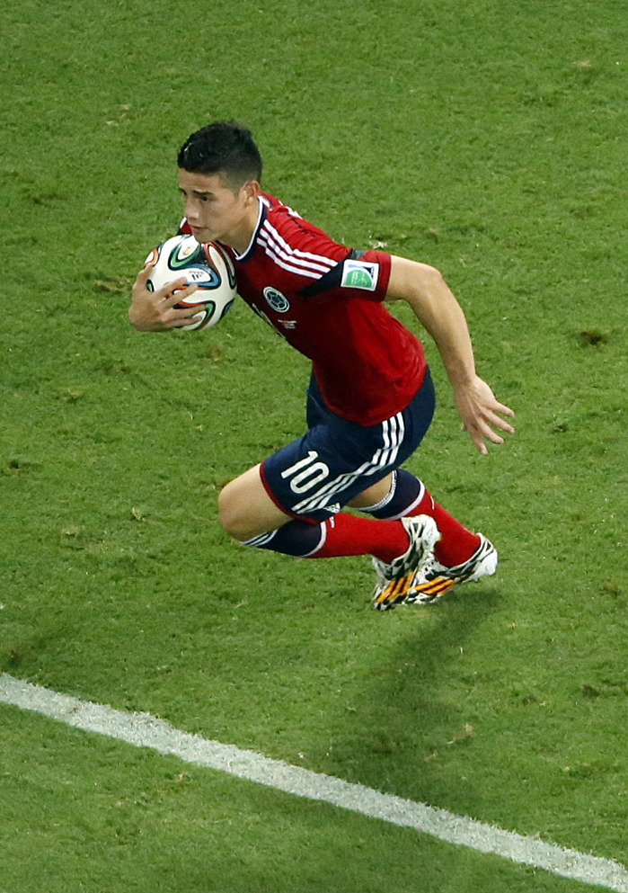 Colombia's James Rodriguez grabs the ball after scoring on a penalty during the World Cup quarterfinal soccer match between Brazil and Colombia at the Arena Castelao in Fortaleza, Brazil, Friday, July 4, 2014. (AP Photo/Fabrizio Bensch, pool)