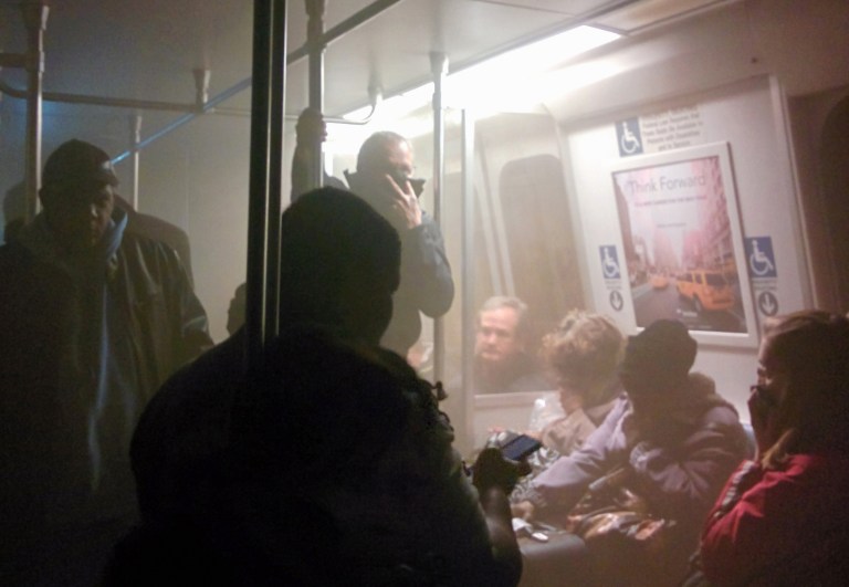 Smoke fills a Washington Metro system subway car near the L'Enfant Plaza station in Washington, Monday, Jan. 12. (AP Photo/Andrew Litwin)